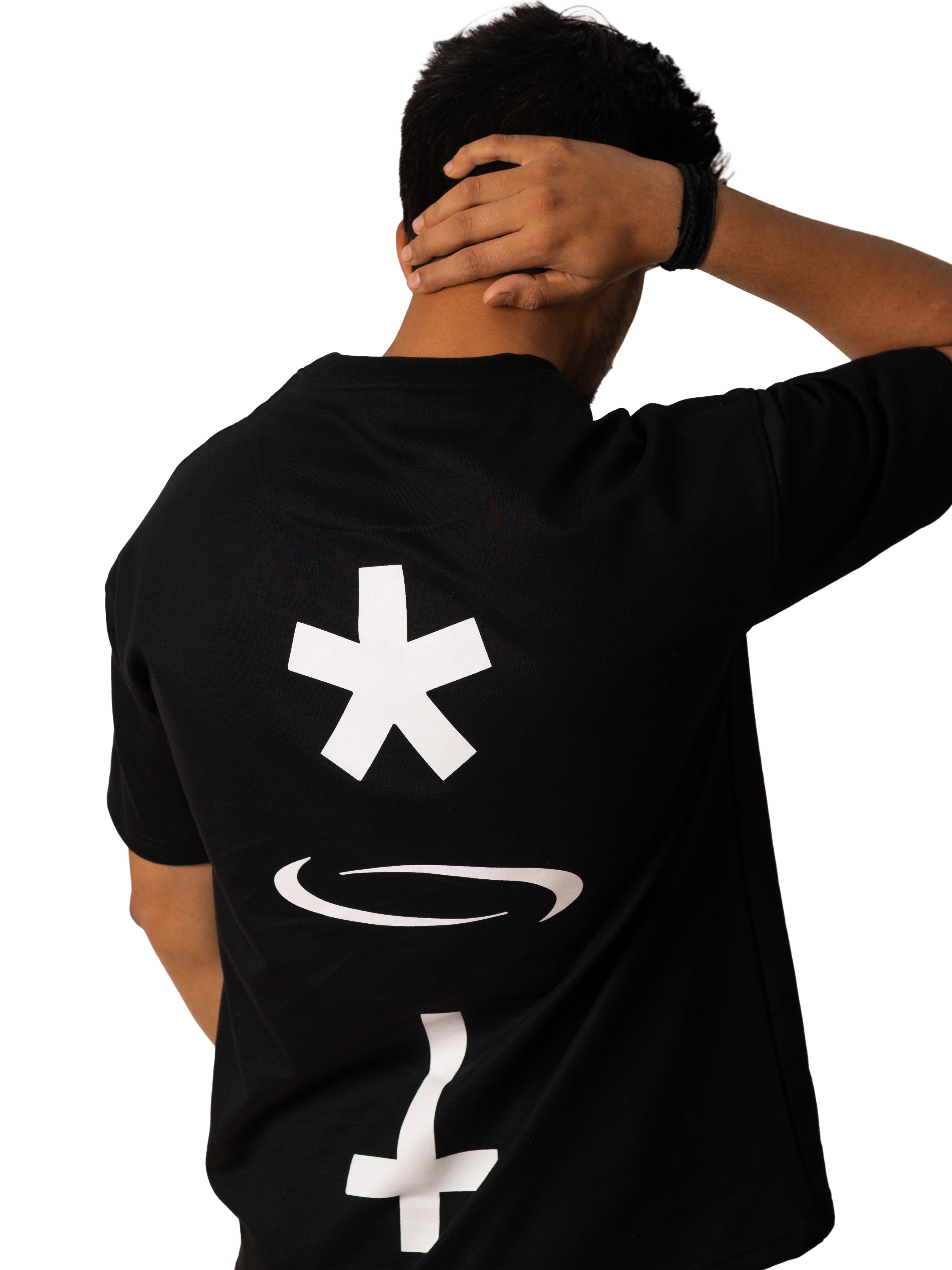 Person wearing a black t-shirt with white symbols on a plain background
