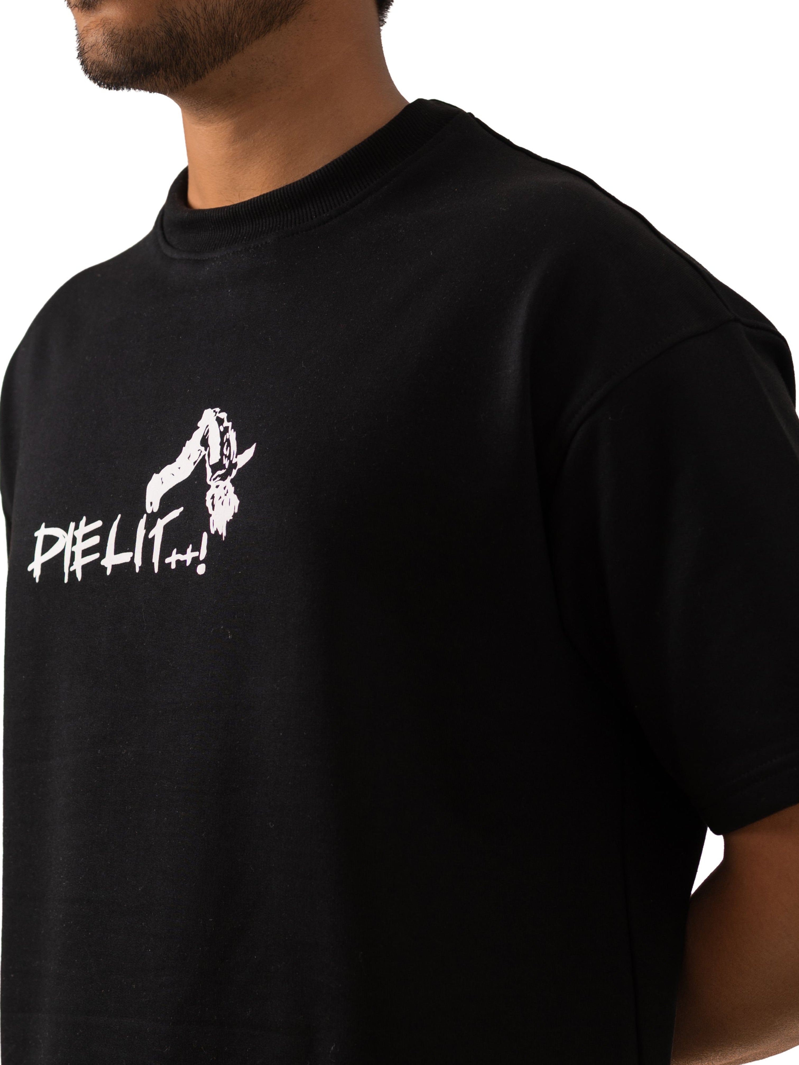 Person wearing a black t-shirt with a white graphic design on a plain background