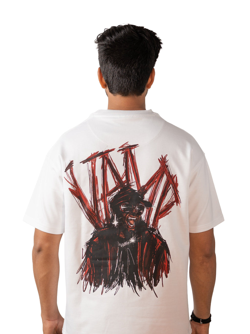 Person wearing a white t-shirt with a graphic design on the back, standing against a white background